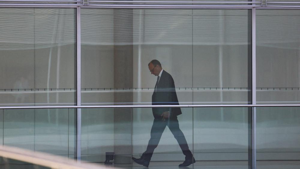 German Chancellor-in-waiting Friedrich Merz walks inside the Reichstag building, that seats the Germany's lower house of parliament, the Bundestag, in Berlin, Germany, March 25, 2025.