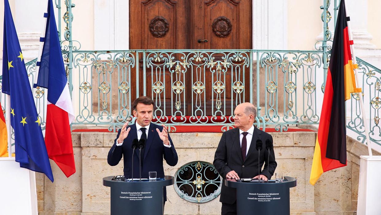 German Chancellor Olaf Scholz listens as French President Emmanuel Macron speaks to reporters on the day of a joint Franco-German cabinet meeting at the German government's guest house, Schloss Meseberg castle north of Berlin, in Gransee, Germany, May 28, 2024.