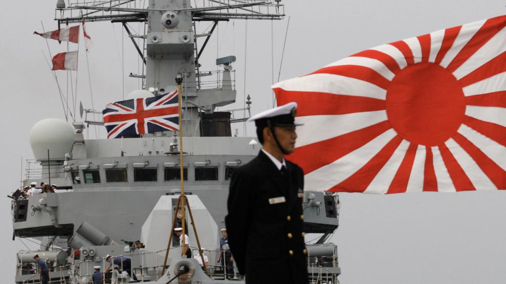 Japanese naval officer stands in front of British Navy vessel Monmouth during the Proliferation Security Initiative Exercise at Yokosuka port