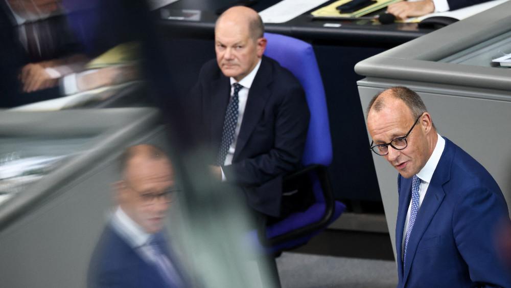 German Chancellor Olaf Scholz watches German Christian Democratic Union (CDU) leader Friedrich Merz speaking during a session of the lower house of parliament Bundestag, in Berlin, Germany, October 16, 2024.