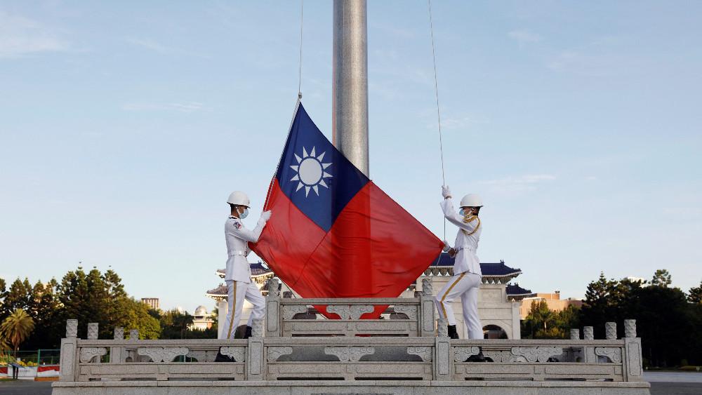 Honour guard members take part in a flag-raising ceremony at Chiang Kai-shek Memorial Hall in Taipei, Taiwan August 6, 2022.