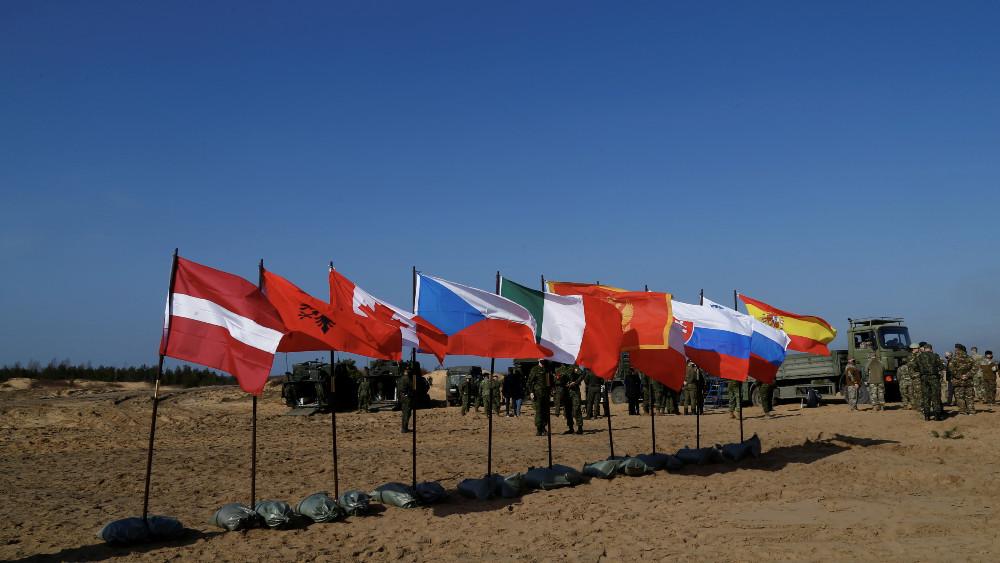NATO enhanced Forward Presence battle group member states flags flutter during military exercise Crystal Arrow 2021 in Adazi, Latvia March 26, 2021.