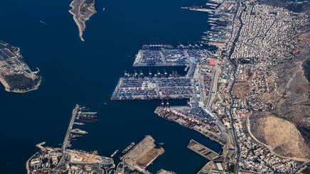 Aerial view from an airplane window of Pireaus port GRPIR. The majority of Port of Piraeus is owned by China COSCO Shipping. Piraeus, Greece, August 7, 2022.