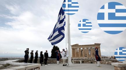 Members of the Presidential Guard raise the Greek flag in front of the Parthenon temple atop the Acropolis during celebrations of the 200th anniversary of the Greek War of Independence as Greek Prime Minister Kyriakos Mitsotakis and Greek President Katerina Sakellaropoulou attend the ceremony in Athens, Greece, March 25, 2021.