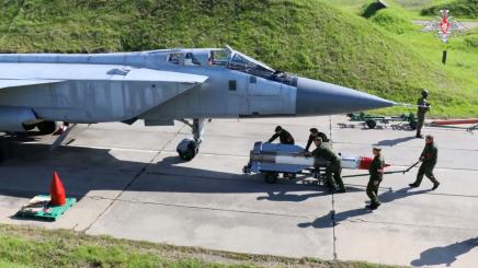 Personnel operate near a jet plane during drills, conducted by service members of Russia's Southern and Central military districts and Aerospace Forces to practice installing dummy warheads on launchers as part of the third stage of tactic nuclear weapons exercises, at an undisclosed location in Russia, in this still image from video released August 1, 2024.