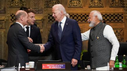 US President Joe Biden, France's President Emmanuel Macron, Germany's Chancellor Olaf Scholz and India's Prime Minister Narendra Modi greet each other during the first working session of the G20 leaders' summit in Bali, Indonesia, November 15, 2022.